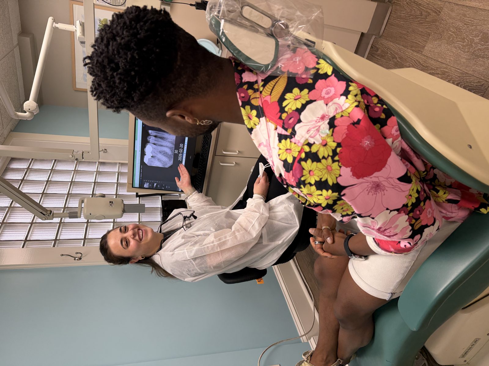 A dentist examining a patient during an urgent same-day emergency visit